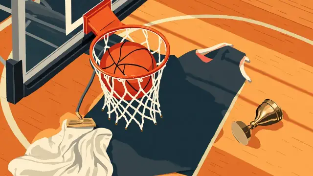 A basketball sits inside a white net hanging from a hoop, with a blank jersey on a hanger, a folded towel, and a small gold trophy arranged on the hardwood court.
